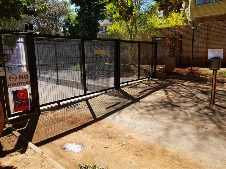 Automated sliding gate at a complex entrance