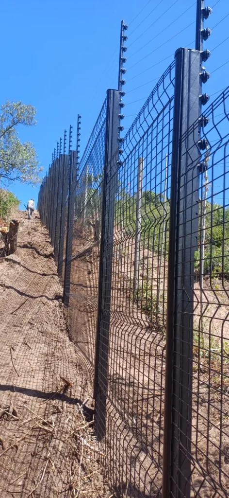 Clearview and electric fence climbing a sandy dune, coastal estate, Plettenberg Bay