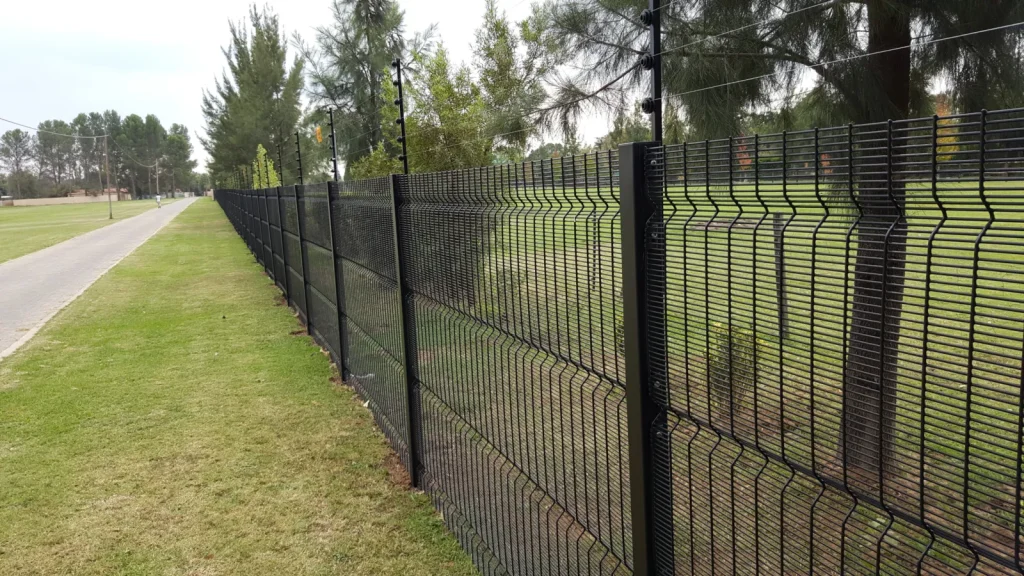 Black clear view fence with an electric fence on top along a large property's road frontage