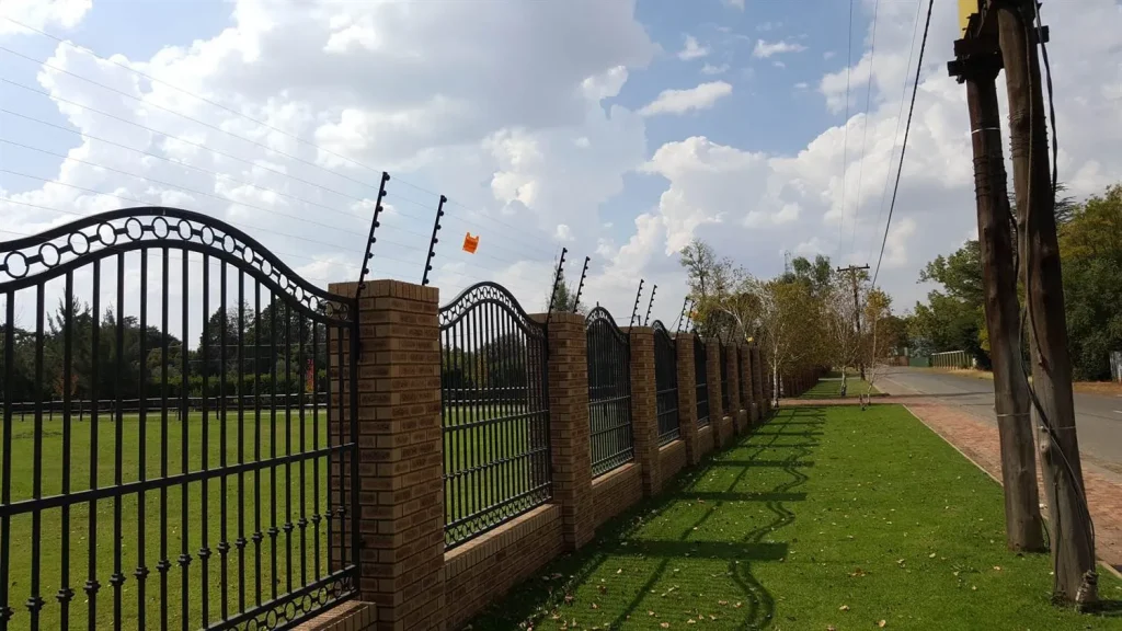 Electric fence on brick pillars and railings