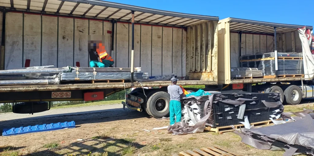 Clearview fence panels being unloaded from a truck on site, coastal estate, Plettenberg Bay